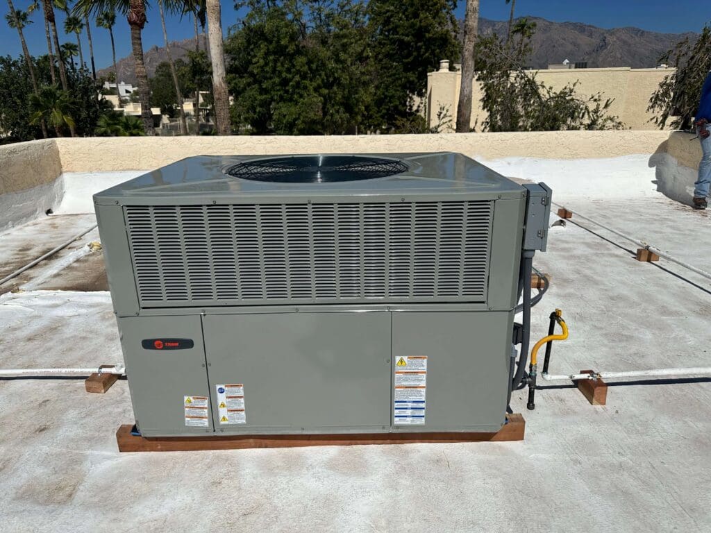 Rooftop air conditioning unit under sunlight.