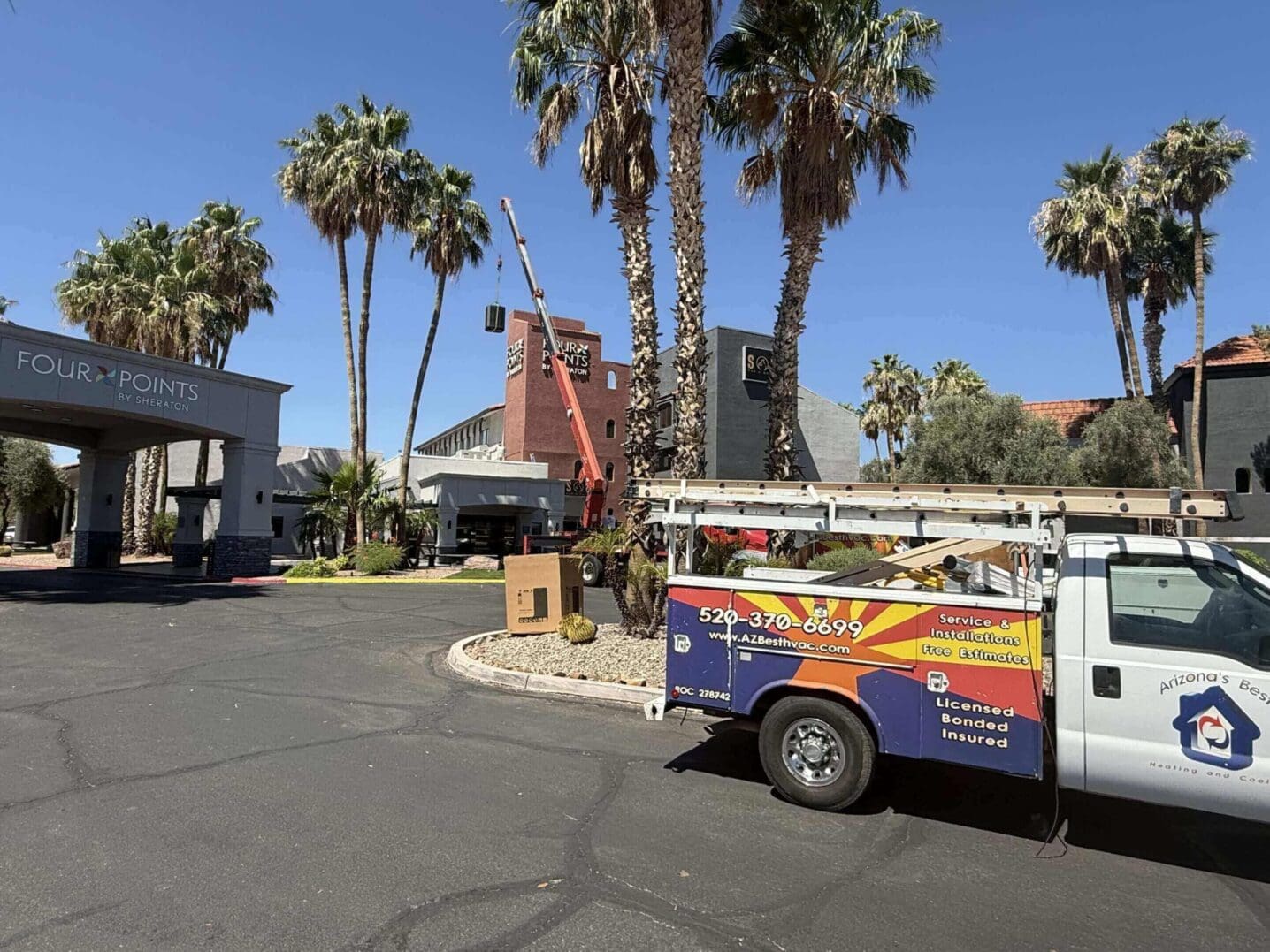 Utility workers handle palm tree maintenance in a sunny parking lot.