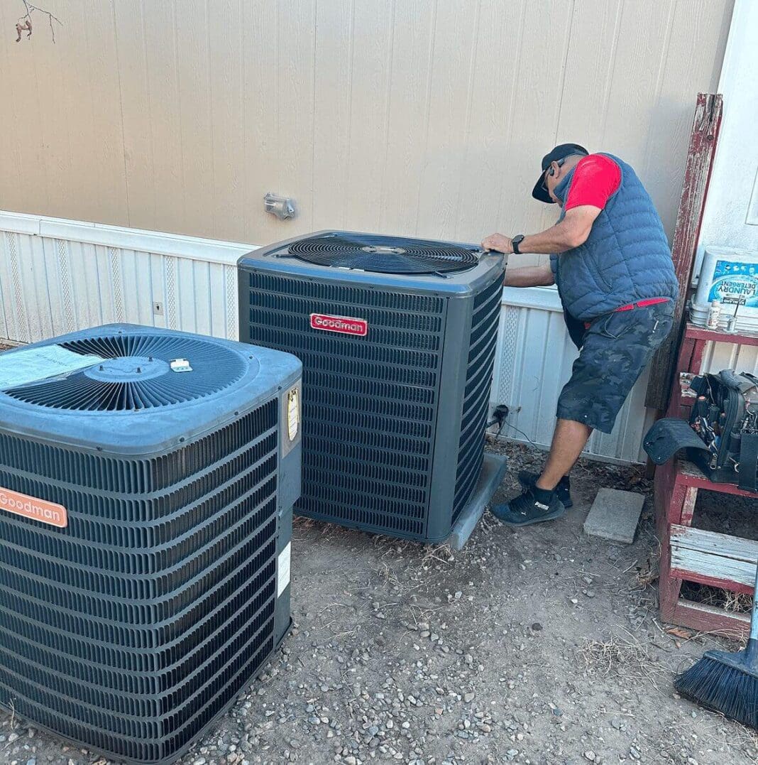 Technician repairing outdoor air conditioning units.