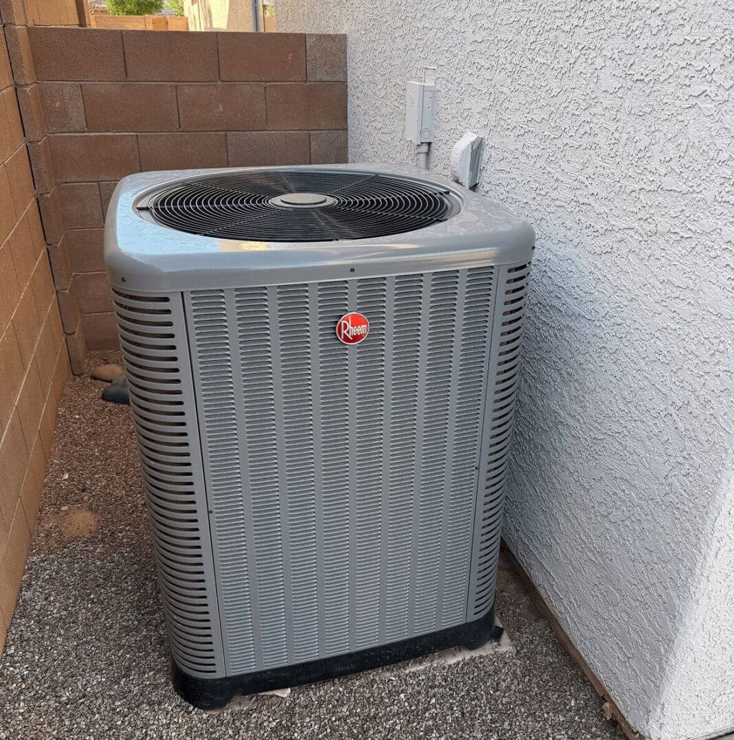 Outdoor air conditioning unit near brick wall.