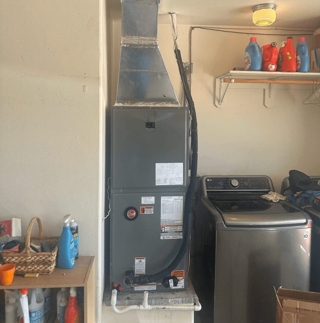 Laundry room with washer and HVAC system.